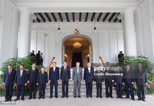 Lee Hsien Loong, Singapore's prime minister, center, joins Association of Southeast Asian Nations defense chiefs for a group photograph at the palace...