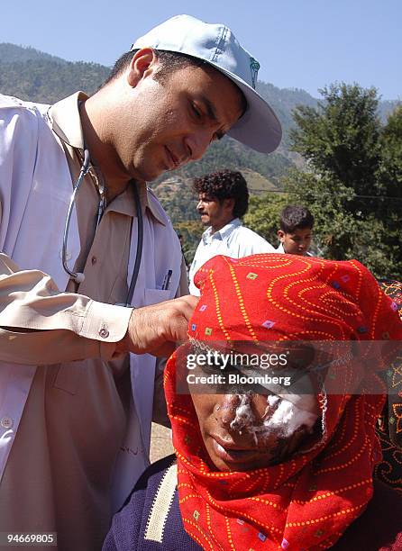 Medic provides first aid to an injured Pakistani woman on Sunday, October 9, 2005 in the town of Balakot in Pakistan's northern area. The major quake...