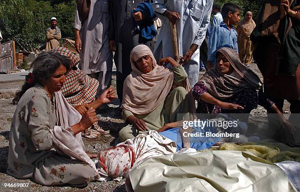 Women mourn over the bodies of their children on Sunday, October 9, 2005 in the town of Balakot in northern Pakistan. The major earthquake on...