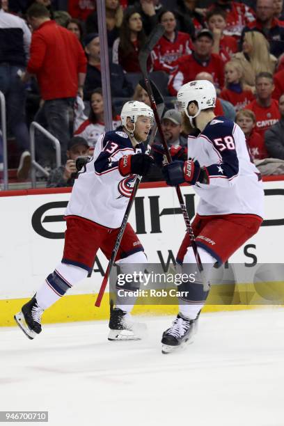 Cam Atkinson of the Columbus Blue Jackets celebrates with David Savard after scoring a first period goal against the Washington Capitals during Game...