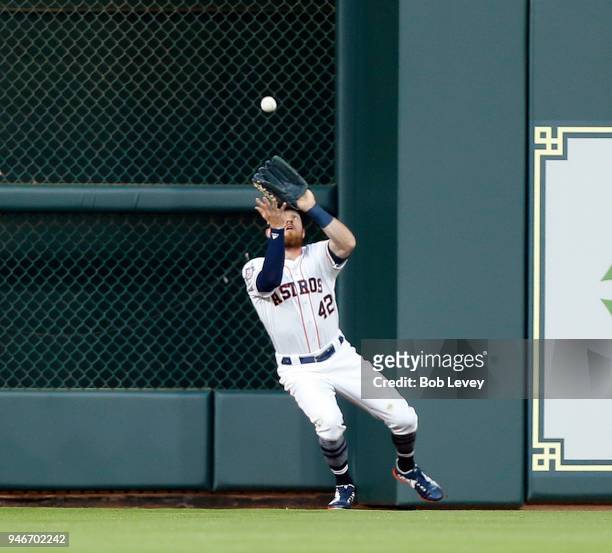 Derek Fisher of the Houston Astros catches a fly ball by Adrian Beltre of the Texas Rangers in the second inning at Minute Maid Park on April 15,...