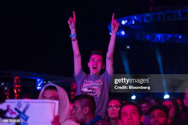 Fan cheers during the Halo World Championship finals in Seattle, Washington, U.S., on Sunday, April 15, 2018. E-sports revenue, consisting of...