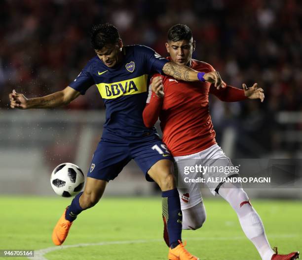 Boca Juniors' forward Walter Bou vies for the ball with Independiente's defender Alan Franco during their Argentina First Division Superliga football...