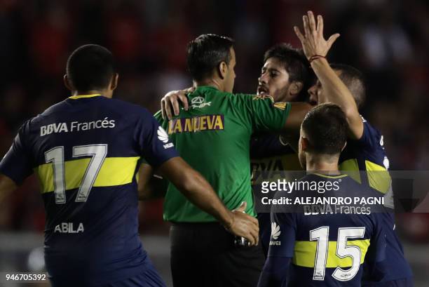 Boca Juniors' midfielder Pablo Perez and defender Leonardo Jara protest to referee Ariel Penel during the Argentina First Division Superliga football...