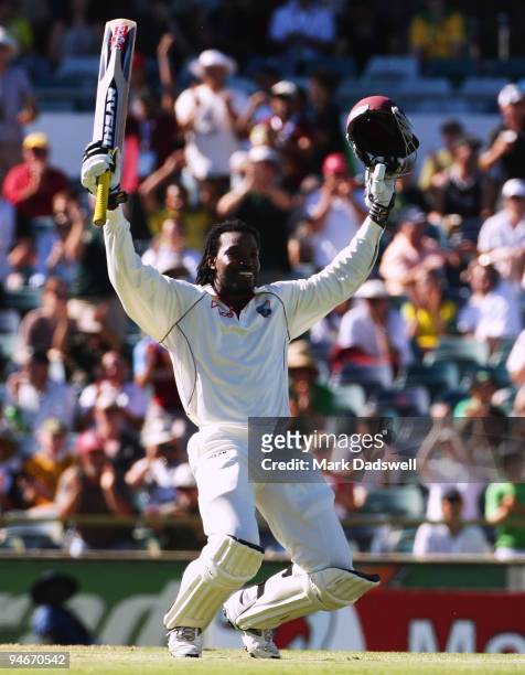 Chris Gayle of the West Indies sinks to his knees as he celebrates his century during day two of the Third Test match between Australia and the West...
