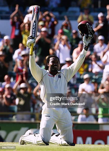 Chris Gayle of the West Indies sinks to his knees as he celebrates his century during day two of the Third Test match between Australia and the West...