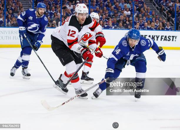 Chris Kunitz of the Tampa Bay Lightning skates against Ben Lovejoy of the New Jersey Devils in Game Two of the Eastern Conference First Round during...