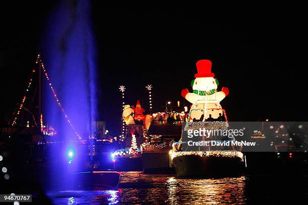 Boats in the 101st annual Newport Beach Christmas Boat Parade are lit with Christmas decorations as they move through through the night on December...