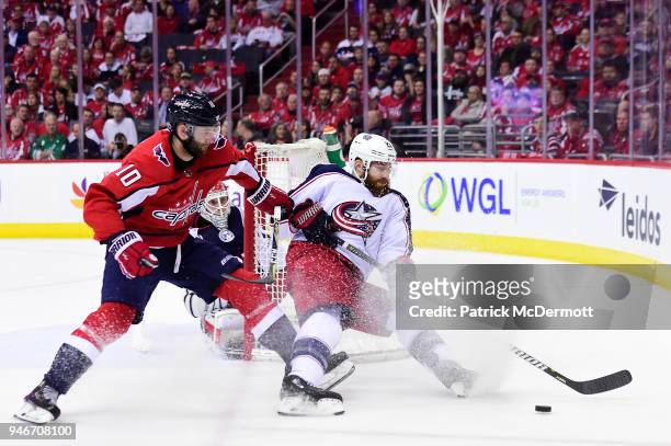 Brett Connolly of the Washington Capitals and Ian Cole of the Columbus Blue Jackets battle for the puck in the first period in Game Two of the...