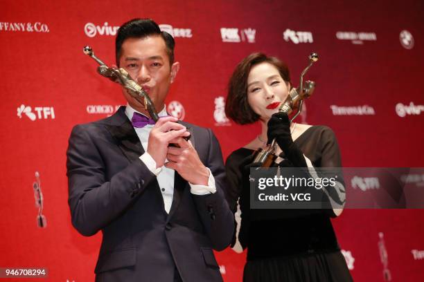 Actress Teresa Mo and actor Louis Koo pose with the Best Actress and the Best Actor trophies at backstage of the 37th Hong Kong Film Awards ceremony...