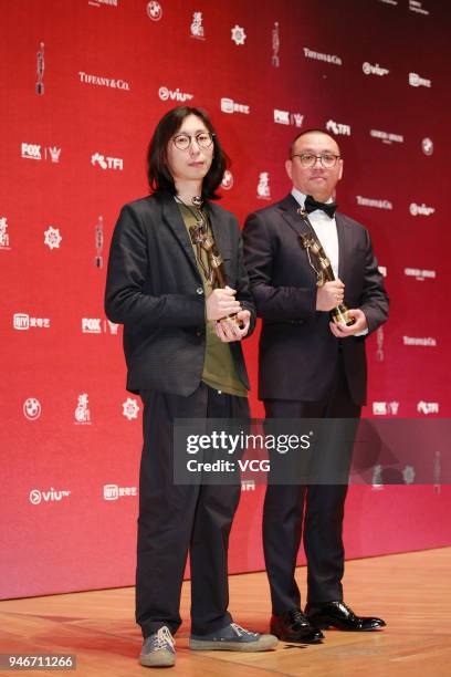 Henri Wong and Eric Xu pose with the Best Visual Effects trophies at backstage of the 37th Hong Kong Film Awards ceremony at Hong Kong Cultural...