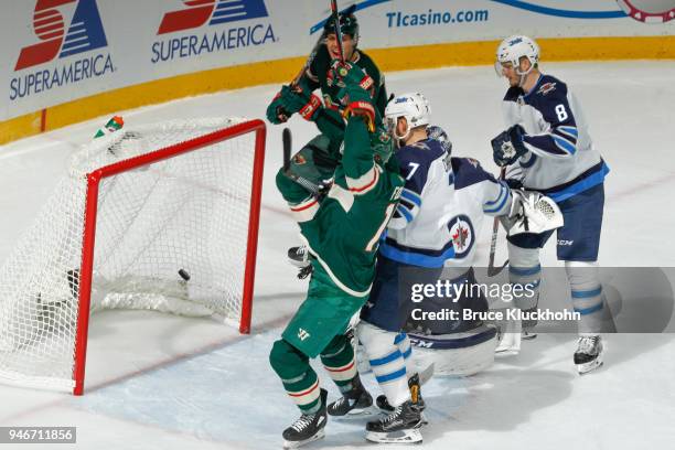 Marcus Foligno of the Minnesota Wild celebrates after scoring a goal against Ben Chiarot and goalie Connor Hellebuyck of the Winnipeg Jets in Game...