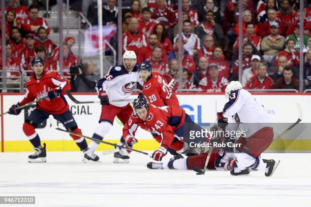 Tom Wilson of the Washington Capitals and Cam Atkinson of the Columbus Blue Jackets go after the puck in the second period during Game Two of the...
