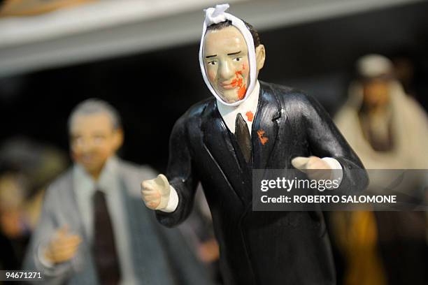 Silvio Berlusconi puppet with a bandage and blood on the face is shown at a Napolitan craftsmen shop in San Gregorio Armeno street, in Naples, on...