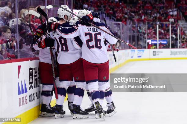 Cam Atkinson of the Columbus Blue Jackets celebrates with his teammates after scoring a goal in the second period against the Washington Capitals in...