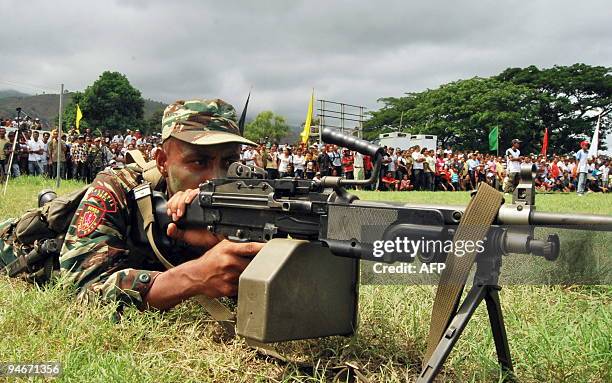 Soldier points his gun as East Timorese soldiers parade during the inauguration of new members of the East Timor Defence Forces in Dili on December...