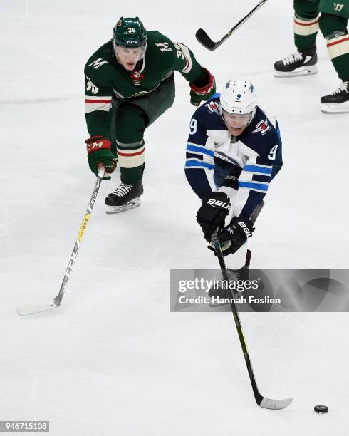 Andrew Copp of the Winnipeg Jets controls the puck against Nick Seeler of the Minnesota Wild during the third period in Game Three of the Western...