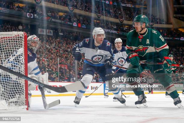 Steve Mason and Paul Stastny of the Winnipeg Jets defend their goal against Zach Parise of the Minnesota Wild in Game Three of the Western Conference...