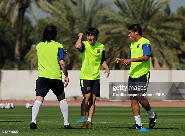 Bojan Krkic of FC Barcelona jokes with his team mates Jonathan dos Santos and Gabriel Milito during a training session for the reserve players from...