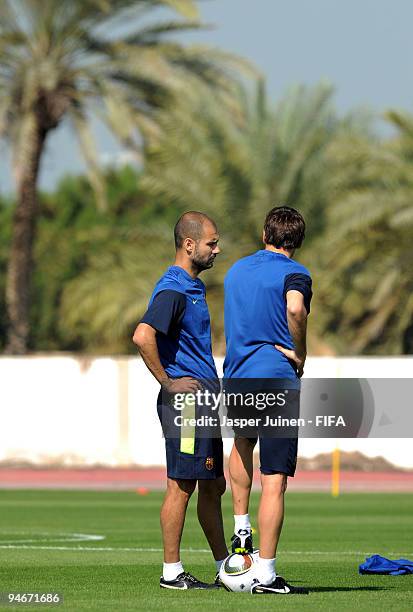 Head coach Josep Guardiola of FC Barcelona chats with a member of his team during a training session for yesterday's match reserve players on...