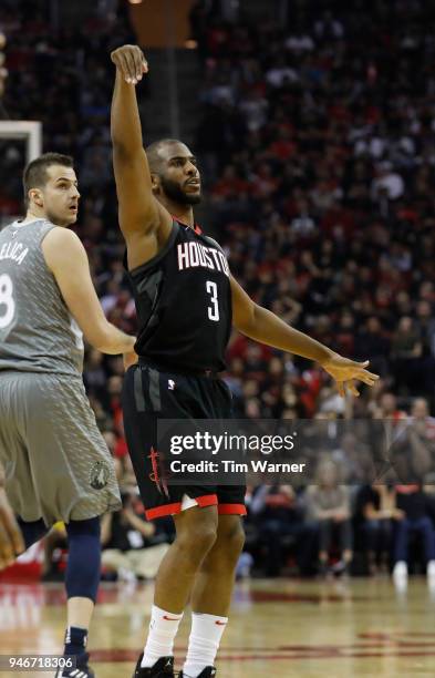 Chris Paul of the Houston Rockets reacts after a three-point shot in the first half against the Minnesota Timberwolves during Game One of the first...