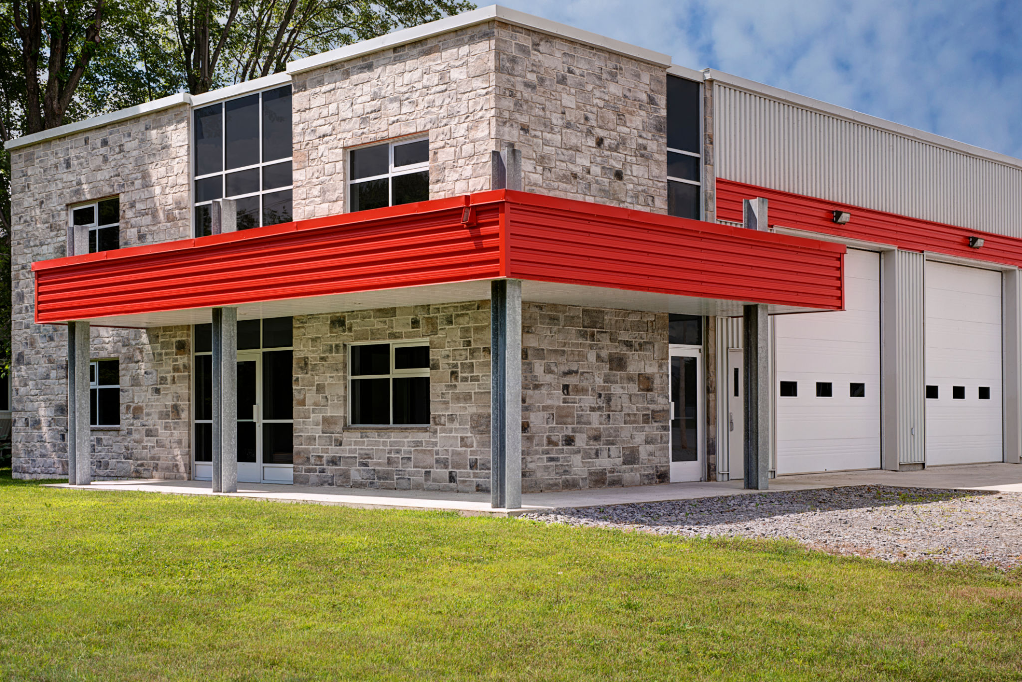 Industrial warehouse entrance and white roller doors on the side. Industrial warehouse entrance and white roller doors on the side.