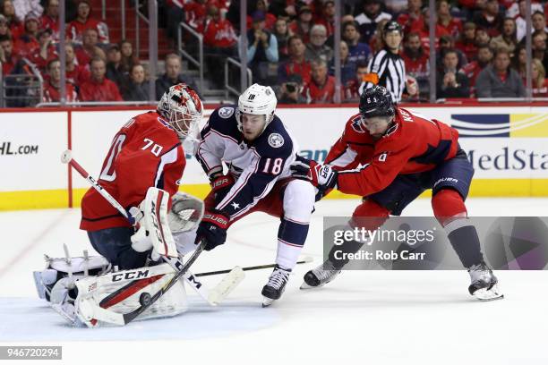 Michal Kempny follows in as goalie Braden Holtby of the Washington Capitals makes a save on a shot by Pierre-Luc Dubois of the Columbus Blue Jackets...