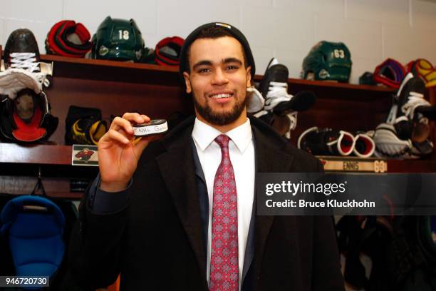 Jordan Greenway of the Minnesota Wild holds up a puck after scoring his first NHL goal in Game Three of the Western Conference First Round during the...