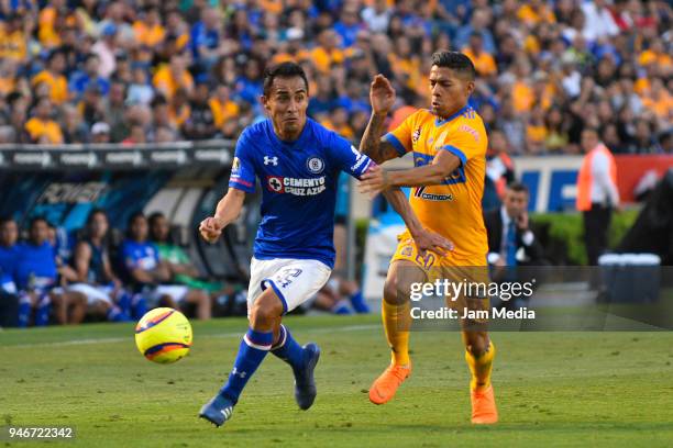 Rafael Baca of Cruz Azul and Javier Aquino of Tigres fight for the ball during the 15th round match between Tigres UANL and Cruz Azul as part of the...
