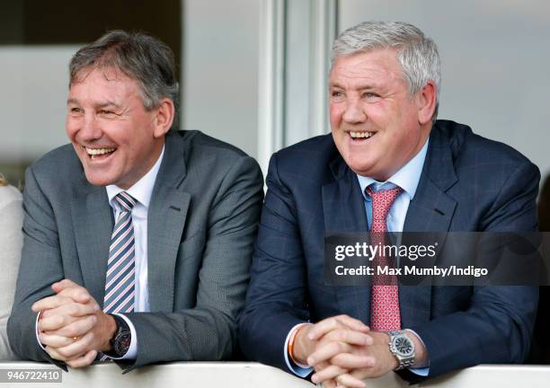 Bryan Robson and Steve Bruce watch the racing as they attend day three 'Grand National Day' of The Randox Health Grand National Festival at Aintree...