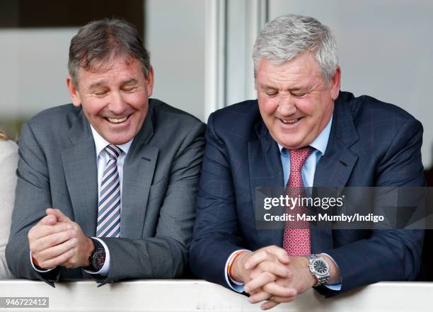 Bryan Robson and Steve Bruce watch the racing as they attend day three 'Grand National Day' of The Randox Health Grand National Festival at Aintree...