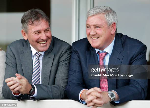 Bryan Robson and Steve Bruce watch the racing as they attend day three 'Grand National Day' of The Randox Health Grand National Festival at Aintree...