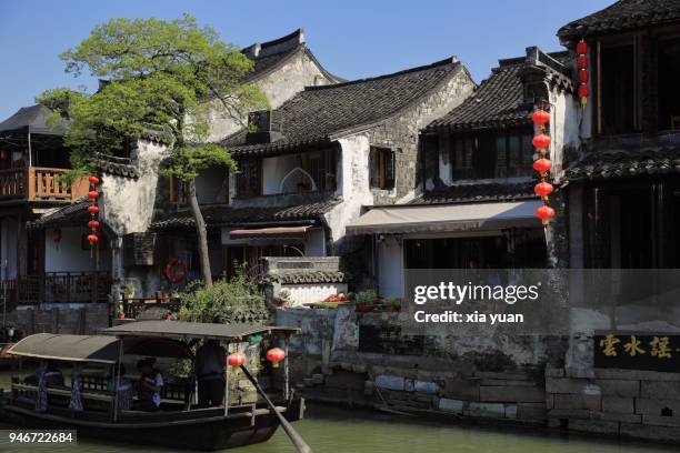 rowboat rowing on canal in xitang ancient town,china - jiaxing fotografías e imágenes de stock