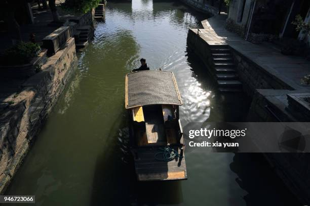 rowboat rowing on canal in xitang ancient town,china - jiaxing fotografías e imágenes de stock