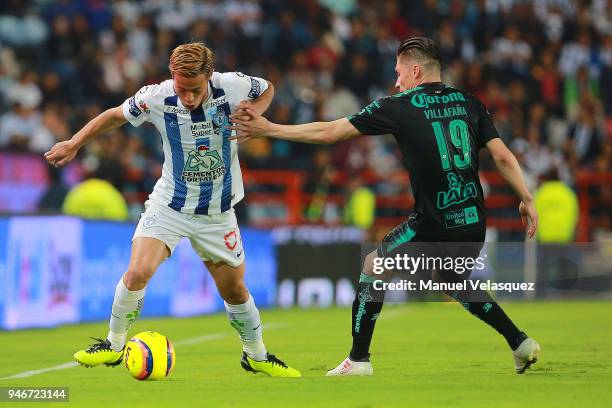 Keisuke Honda of Pachuca struggle for the ball against Jorge Flores of Santos during the 15th round match between Pachuca and Santos Laguna as part...