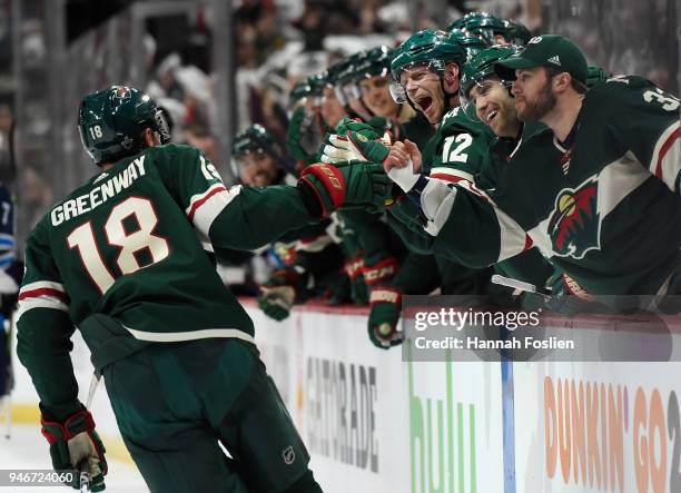 The Minnesota Wild congratulate teammate Jordan Greenway on scoring a goal against the Winnipeg Jets during the second period in Game Three of the...