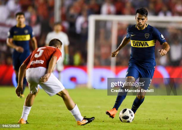 Emmanuel Mas of Boca Juniors drives the ball under pressure of Nicolas Domingo of Independiente during a match between Independiente and Boca Juniors...