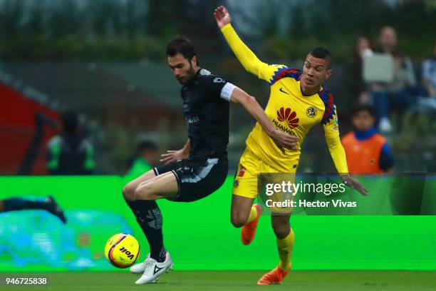 Mateus Uribe of America struggles for the ball with Jose Basanta of Monterrey during the 15th round match between America and Monterrey as part of...