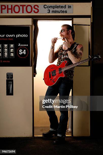 Jesse 'The Devil' Hughes of Eagles of Death Metal poses for a portrait session in a photo booth, touching up his skin, on March 16th 2007 in...