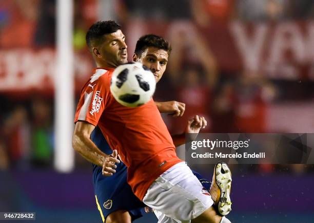 Lisandro Magallan of Boca Juniors fights for the ball with Emmanuel Gigliotti of Independiente during a match between Independiente and Boca Juniors...