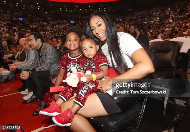 Kiara Morrison the wife of DeMar DeRozan of the Toronto Raptors poses for a photo with the couple"u2019s two daughters before the start of the game...