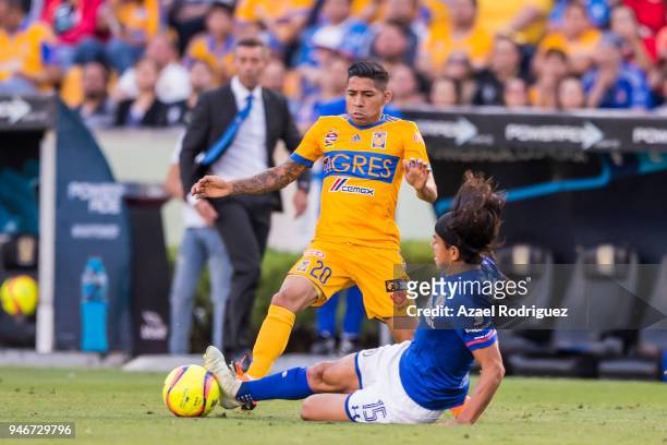 Javier Aquino of Tigres fights for the ball with Gerardo Flores of Cruz Azul during the 15th round match between Tigres UANL and Cruz Azul as part of...