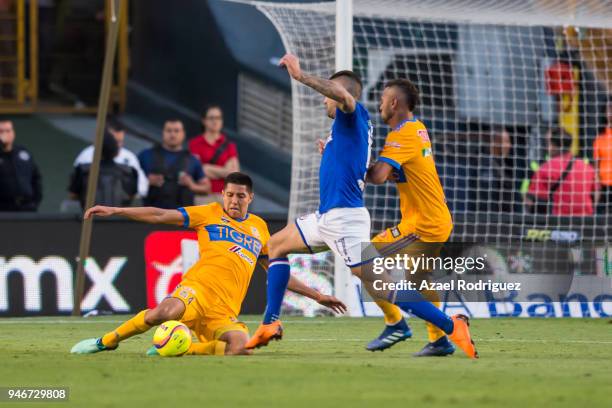 Hugo Ayala and Rafael De Souza of Tigres fight for the ball with Edgar Mendez of Cruz Azul during the 15th round match between Tigres UANL and Cruz...