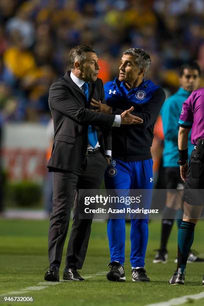 Elias Domingos tries to calm down Pedro Caixinha, coach of Cruz Azul, after he was expeled from the field during the 15th round match between Tigres...