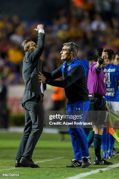 Elias Domingos tries to calm down Pedro Caixinha, coach of Cruz Azul, after he was expeled from the field during the 15th round match between Tigres...