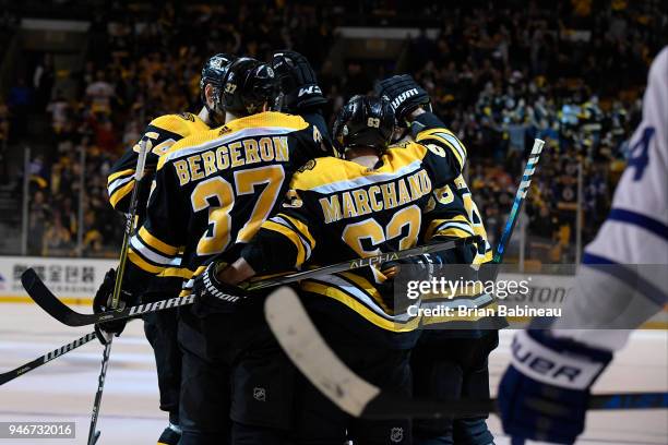 Patrice Bergeron and Brad Marchand of the Boston Bruins celebrate a goal against the Toronto Maple Leafs during the First Round of the 2018 Stanley...