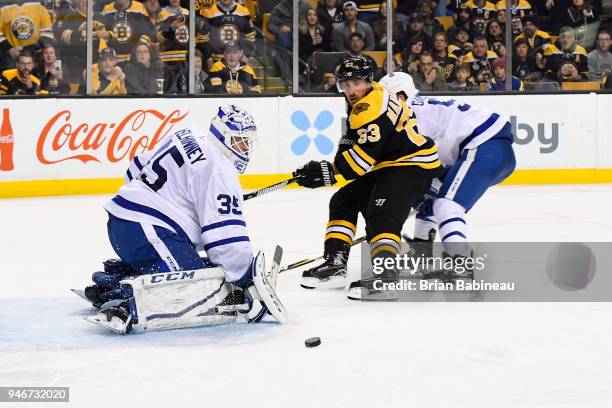 Brad Marchand of the Boston Bruins shoots against Curtis McElhinney of the Toronto Maple Leafs during the First Round of the 2018 Stanley Cup...