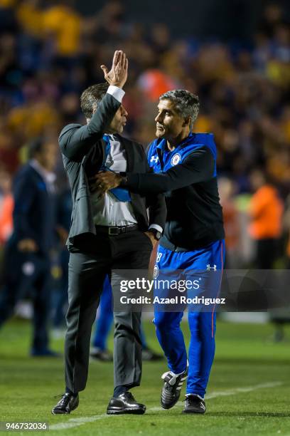 Elias Domingos tries to calm down Pedro Caixinha, coach of Cruz Azul, after he was expeled from the field during the 15th round match between Tigres...