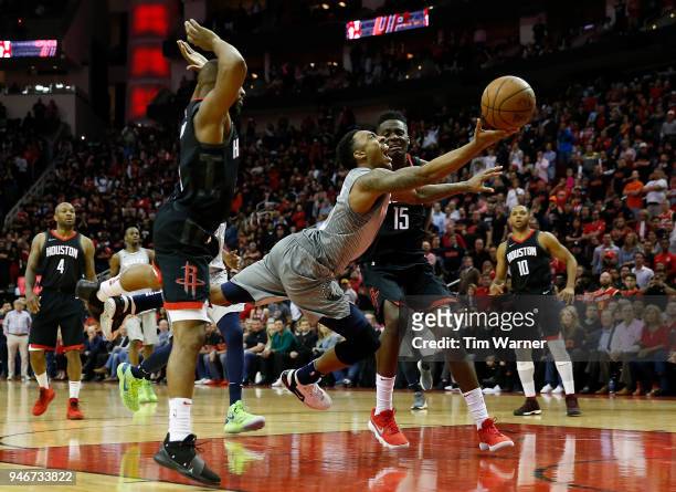 Jeff Teague of the Minnesota Timberwolves goes up for a shot defended by Clint Capela of the Houston Rockets and Chris Paul in the second half during...