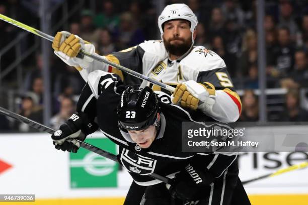 Deryk Engelland of the Vegas Golden Knights cross checks Dustin Brown of the Los Angeles Kings during the second period in Game Three of the Western...